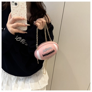 Detail of pink rugby-shaped mini bag with white stripes and elegant gold chain strap