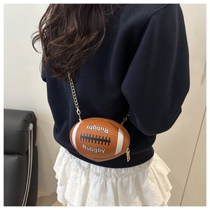 Detail view of the rugby-shaped crossbody bag with white stripes and chain strap