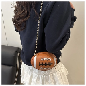 Macro view of unique rugby-shaped crossbody bag with letter print and gold chain