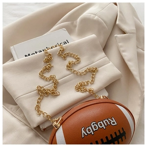 Detailed macro shot of the brown faux leather texture on rugby-shaped crossbody bag
