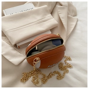 Interior view showing the storage space of the brown rugby-shaped crossbody bag