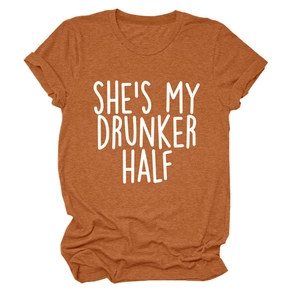 Close-up of caramel orange t-shirt featuring She's My Drunker Half white slogan text