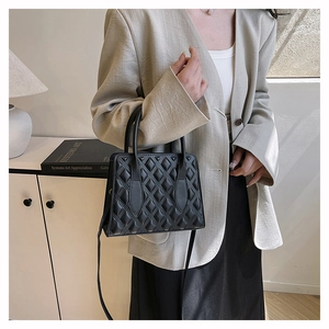 Close-up of black quilted handbag with diamond stitching and high-quality leather texture