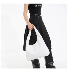 Detailed view of white woven embossed texture on a large hobo shoulder bag for women