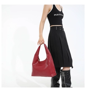Close-up of red hobo bag featuring woven texture and large capacity for daily use