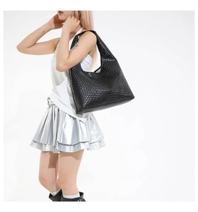 Close-up of a large black woven leather hobo shoulder bag with Intrecciato pattern texture