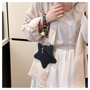Detail of star-shaped black faux leather coin purse with LOVE letter strap and gold zipper