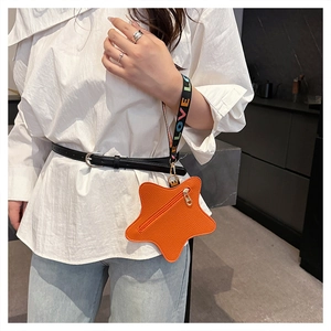 Close-up of orange star-shaped coin purse with litchi texture and LOVE embroidered strap