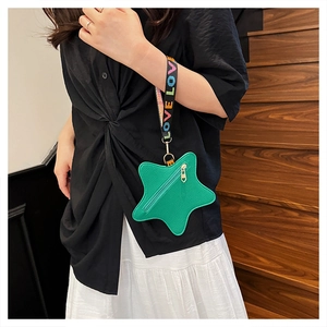 Detail of green star-shaped coin purse with litchi texture and LOVE LOVE wrist strap