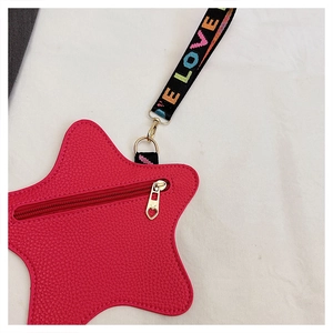 Dettaglio borsa a stella con cerniera a cuore e tracolla con scritta LOVE