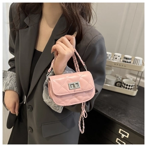 Close-up of pink quilted mini crossbody bag with silver twist lock and chain strap