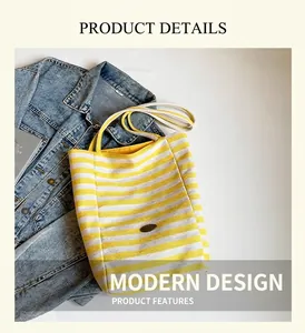 Detailed view of yellow striped canvas tote bag on denim jacket with textured fabric handles