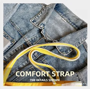 Detail of yellow canvas tote bag with contrast woven strap against denim background