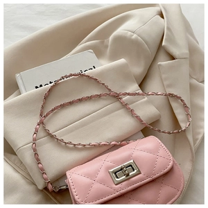 Close-up of pink quilted crossbody bag with silver twist lock and chain strap detail