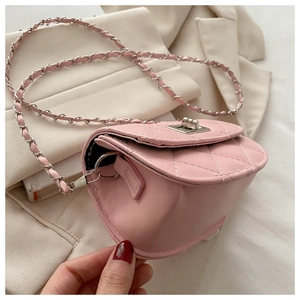 Close-up of pink quilted mini crossbody bag with silver chain strap and twist lock detail