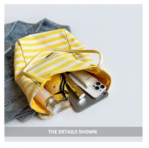 Interior view of striped canvas tote showing large capacity for umbrella and phone