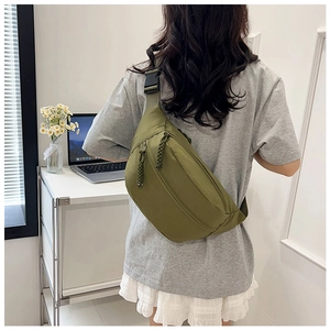 Detailed view of olive green nylon crossbody bag with adjustable strap and buckle closure