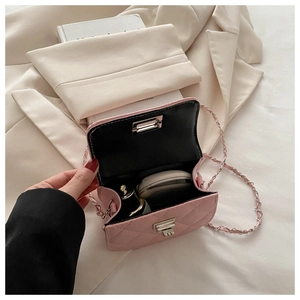 Pink quilted mini crossbody bag detail showing interior space for lipstick and cosmetics