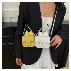 Detailed view of woven flap bags with metal flower clasp and elegant bow decoration
