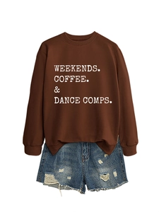 Close-up of coffee brown sweatshirt with white typography and ripped denim shorts