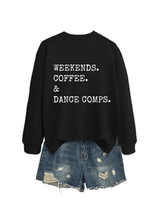 Flat lay of black sweatshirt with white text slogan and distressed blue denim shorts