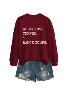 Flat lay of burgundy slogan sweatshirt paired with distressed blue denim shorts