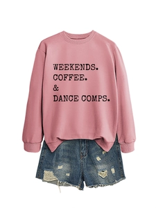 Flat lay of pink cotton sweatshirt with coffee text and distressed denim shorts