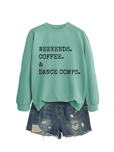 Detail of mint green sweatshirt with WEEKENDS COFFEE DANCE print and ripped denim shorts