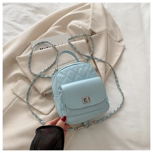 Detailed close-up of light blue quilted leather bag with silver twist lock and chain strap