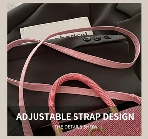 Detail of pink woven texture bag with adjustable leather strap and golden D-ring hardware