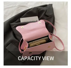Macro view of the pink saddle bag showing interior capacity for a phone and wallet