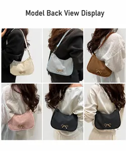 Detail view of colorful hobo bags with ripple texture and metal bow decoration