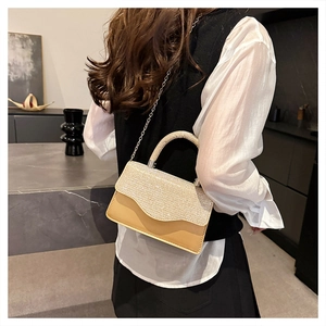 Detail view of champagne gold crossbody bag with rhinestone flap and metal handle