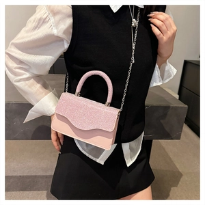 Detail view of light pink sequin fabric and smooth leather crossbody bag with chain