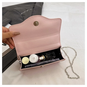Top view of pink crossbody bag interior showing storage space for phone and makeup