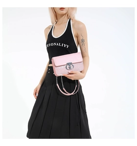 Detailed shot of pink sequin crossbody bag featuring a silver metal logo clasp lock