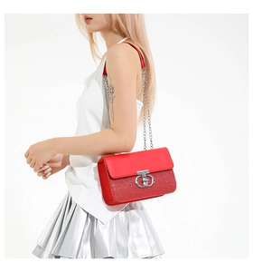 Detail of red sequin shoulder bag featuring a silver metal ring buckle and chain strap