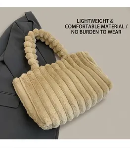 Detail of plush beige shoulder bag with unique faux fur pom-pom strap and striped texture