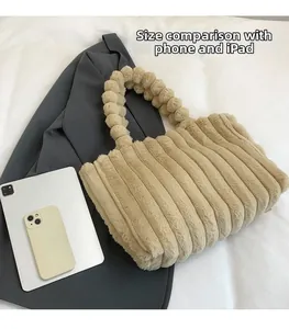Faux fur tote bag with vertical stripes shown next to tablet for size reference