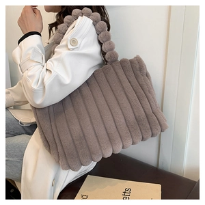 Detail of plush tote bag with vertical stripes and creative bobble handle design