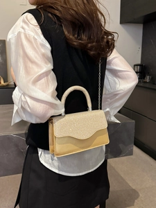 Elegant champagne gold evening handbag with glitter finish and chain strap for women