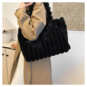 Macro shot of black faux fur tote bag with vertical quilted texture and fluffy straps