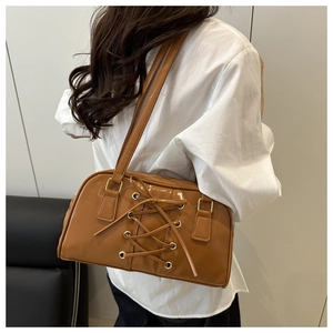 Detailed view of caramel brown PU shoulder bag featuring lace-up design and gold hardware