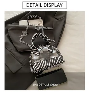 Detailed shot of transparent PVC shell bag with zebra print faux leather and silver chain strap
