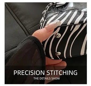 Detail view of zebra pattern leather stitching with silver metal buckle on shell bag