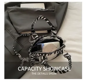 Detail showing the inner capacity of this zebra print crossbody bag with cosmetics