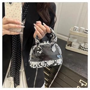 Macro detail of snakeskin pattern and transparent PVC texture on a chic handbag