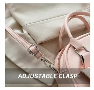 Detail of pink shell pillow bag showing adjustable strap with silver metal buckle and hook