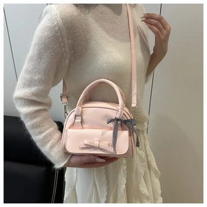Pink bow handbag with adjustable shoulder strap and stylish black-and-white plaid ribbon
