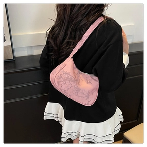 Detailed view of pink floral shoulder bag with bamboo leaf pattern and wide canvas strap